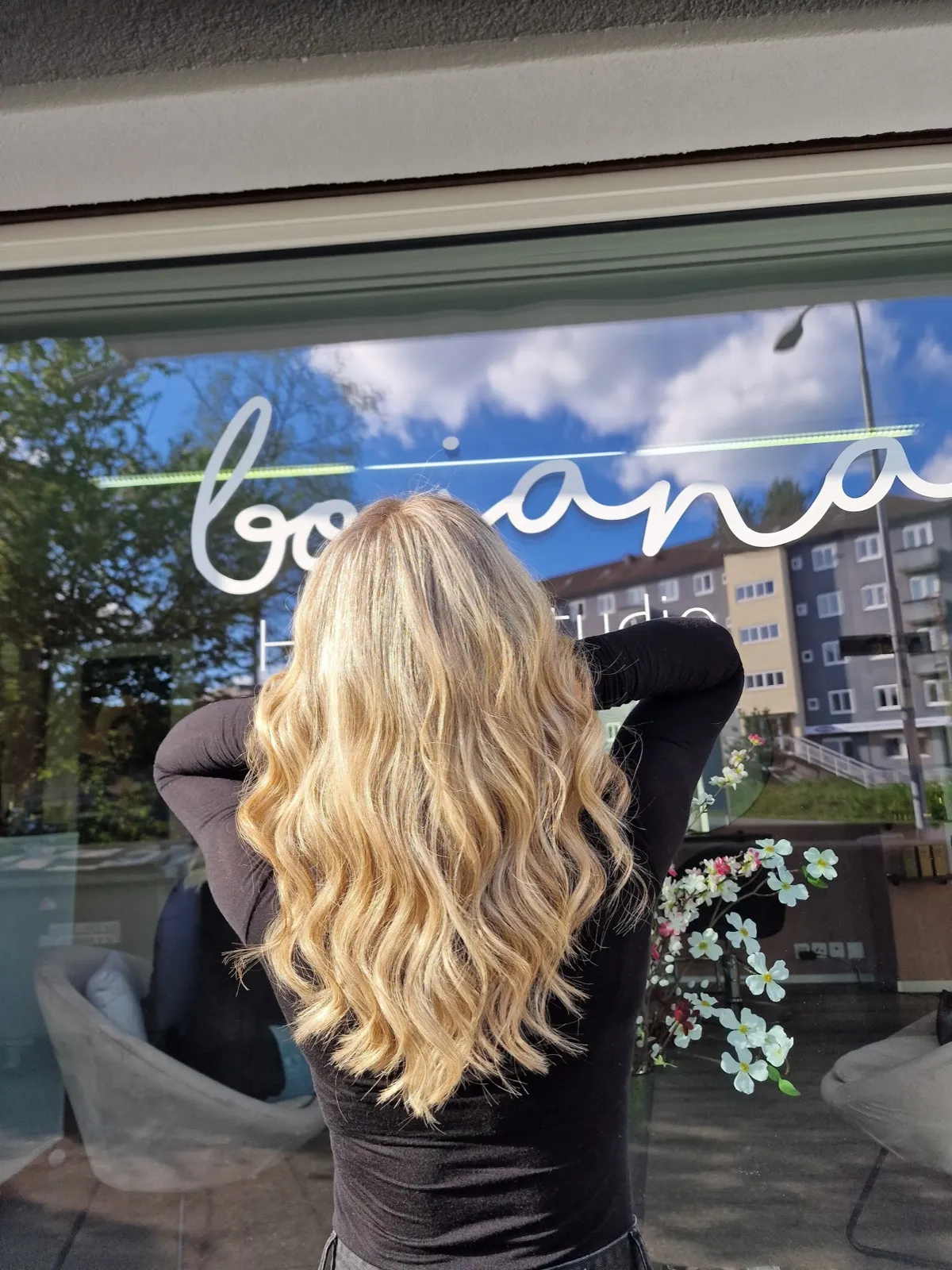 Lange blonde Wellen, aufgehellt und kühl nachgetönt — vor dem Schaufenster an der Berninastrasse